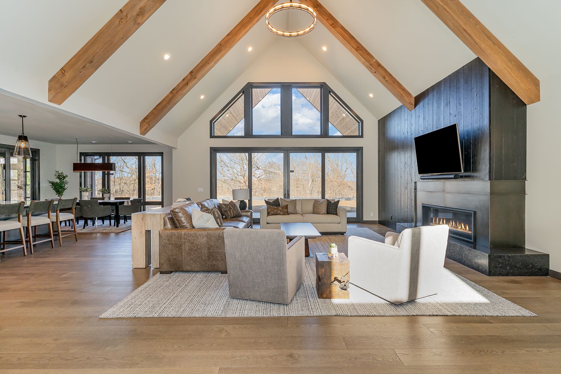 A living room with a vaulted ceiling and a fireplace.