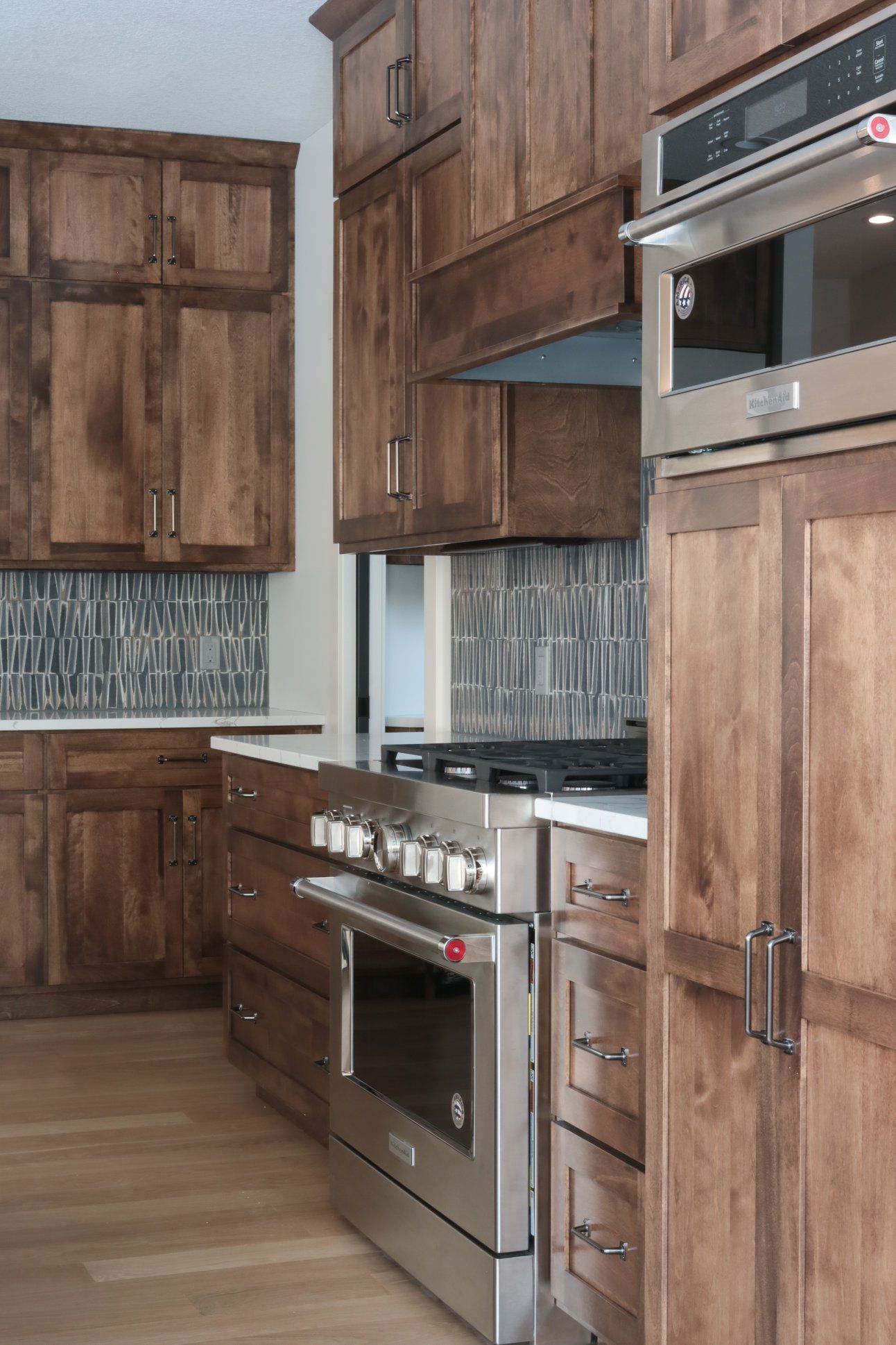 A kitchen with stainless steel appliances and wooden cabinets