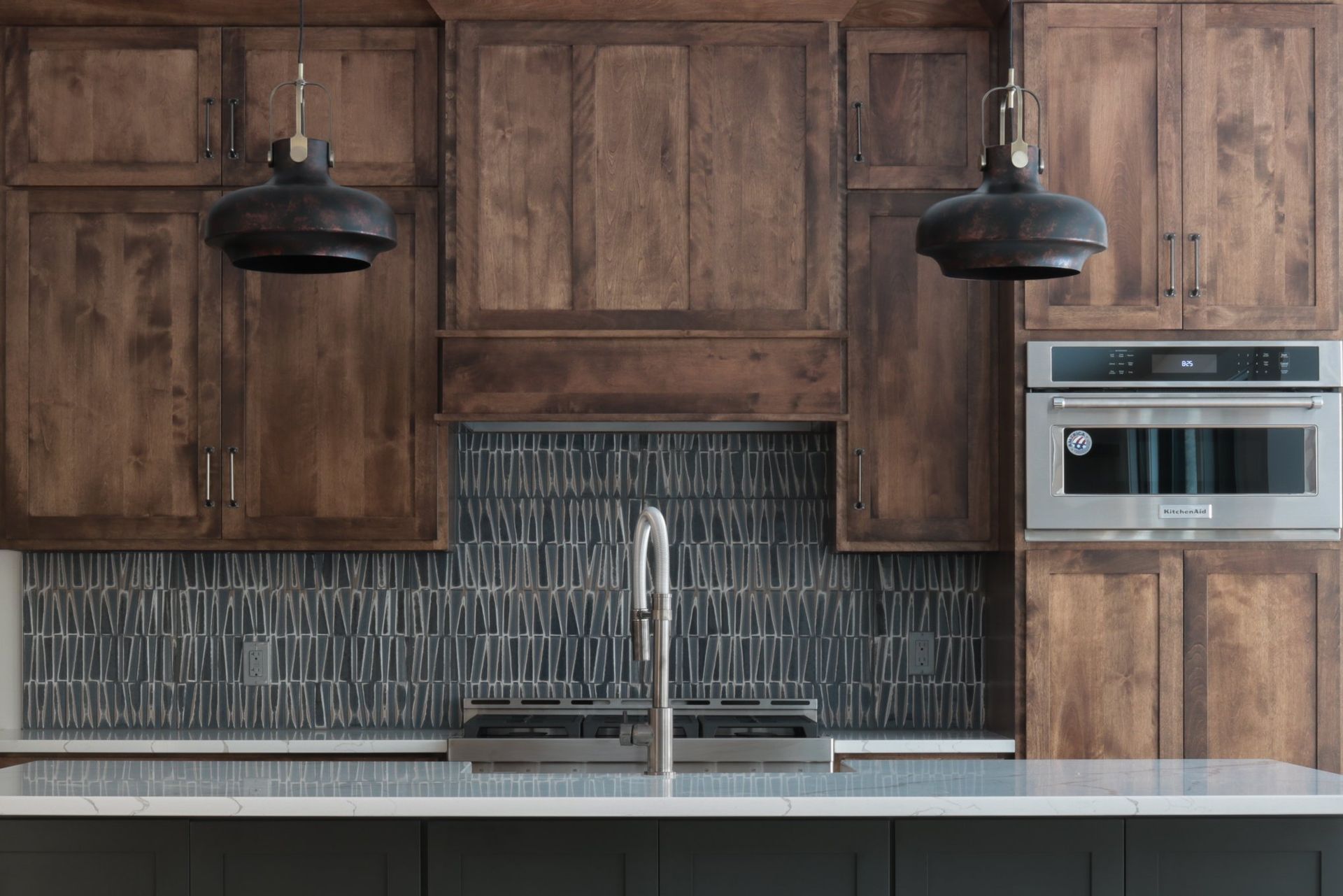 A kitchen with wooden cabinets and stainless steel appliances.
