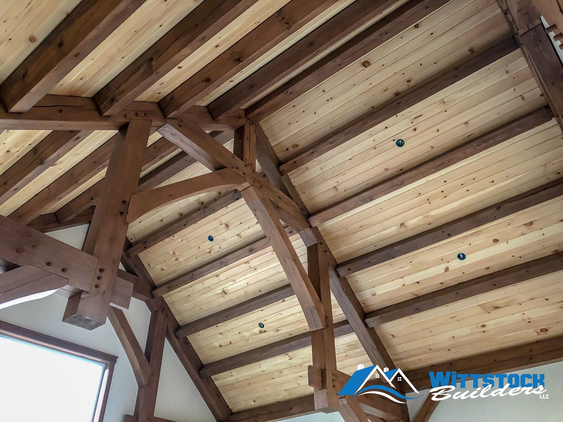 A wooden ceiling with a vaulted ceiling and wooden beams