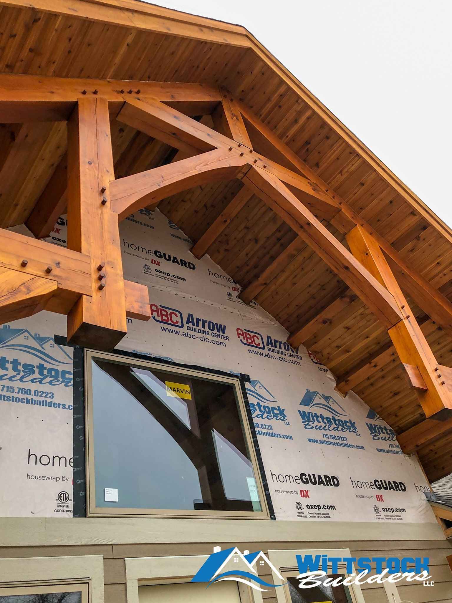 A building under construction with a roof made of wood