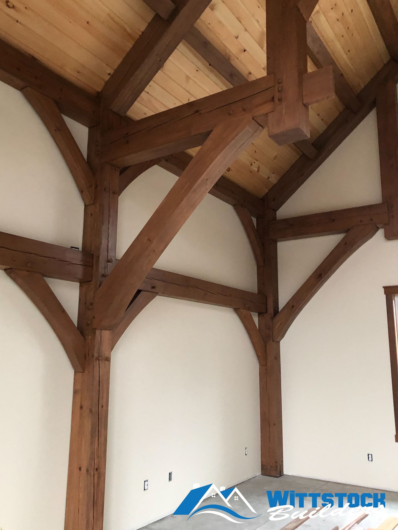 A room with wooden beams and white walls