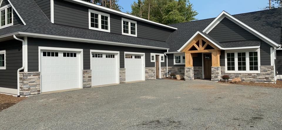 A large house with a lot of garage doors and windows.