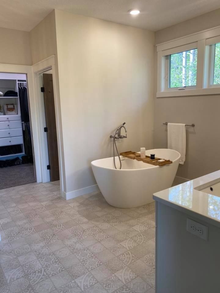 There is a bathtub in the middle of the bathroom.