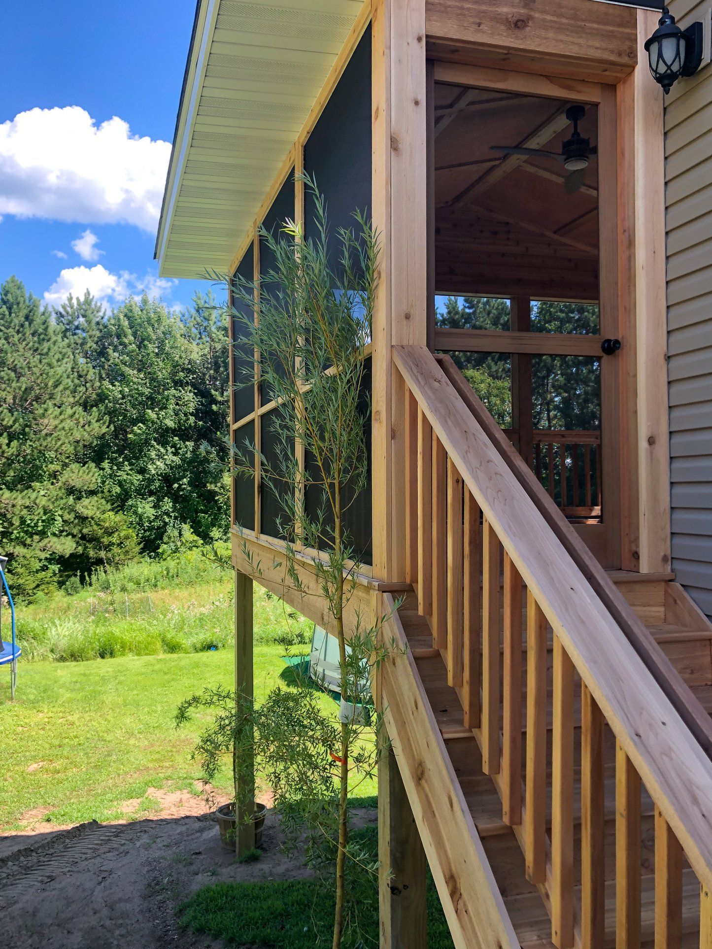 A screened in porch with stairs leading up to it