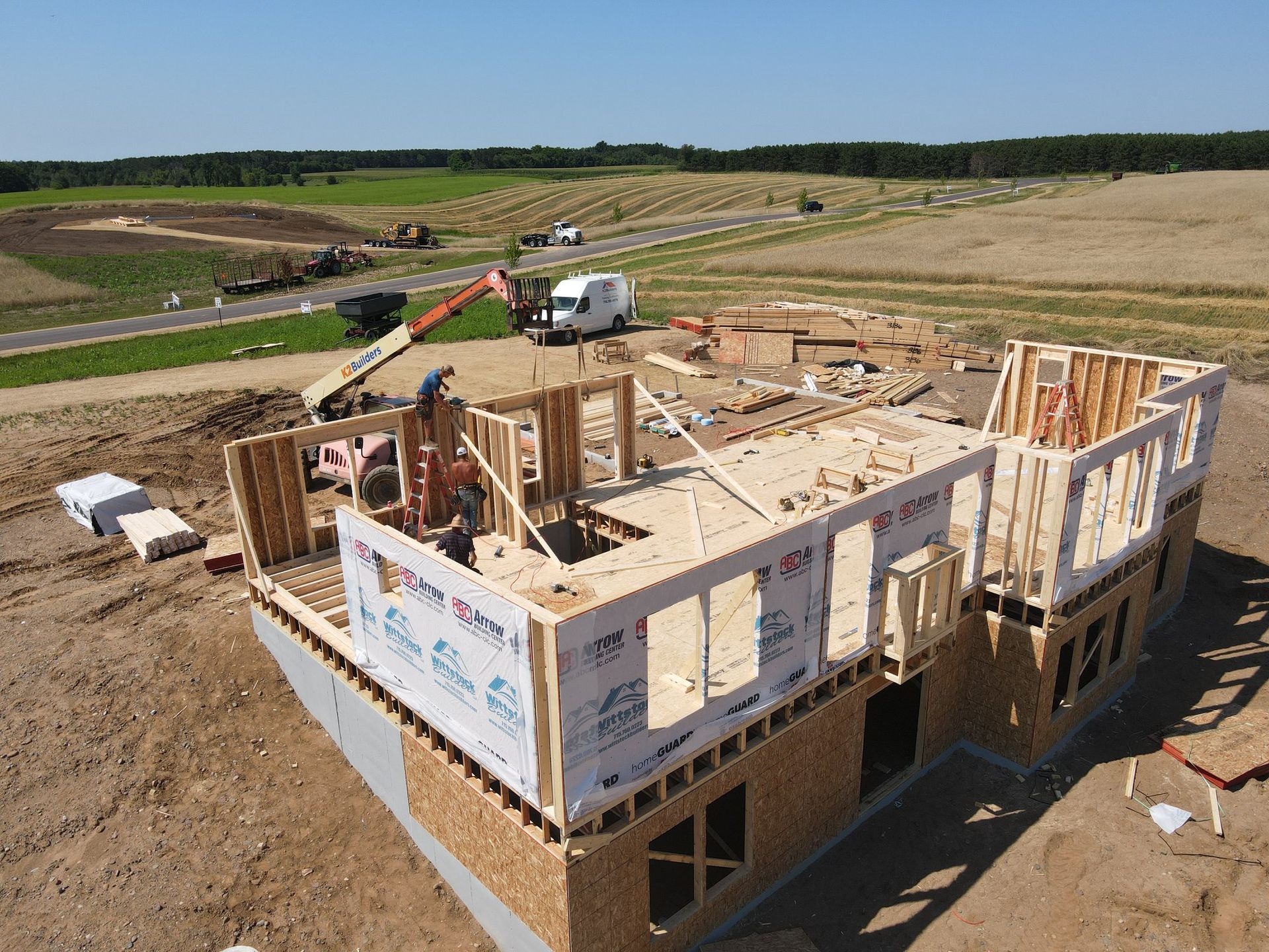 An aerial view of a house under construction in a field.