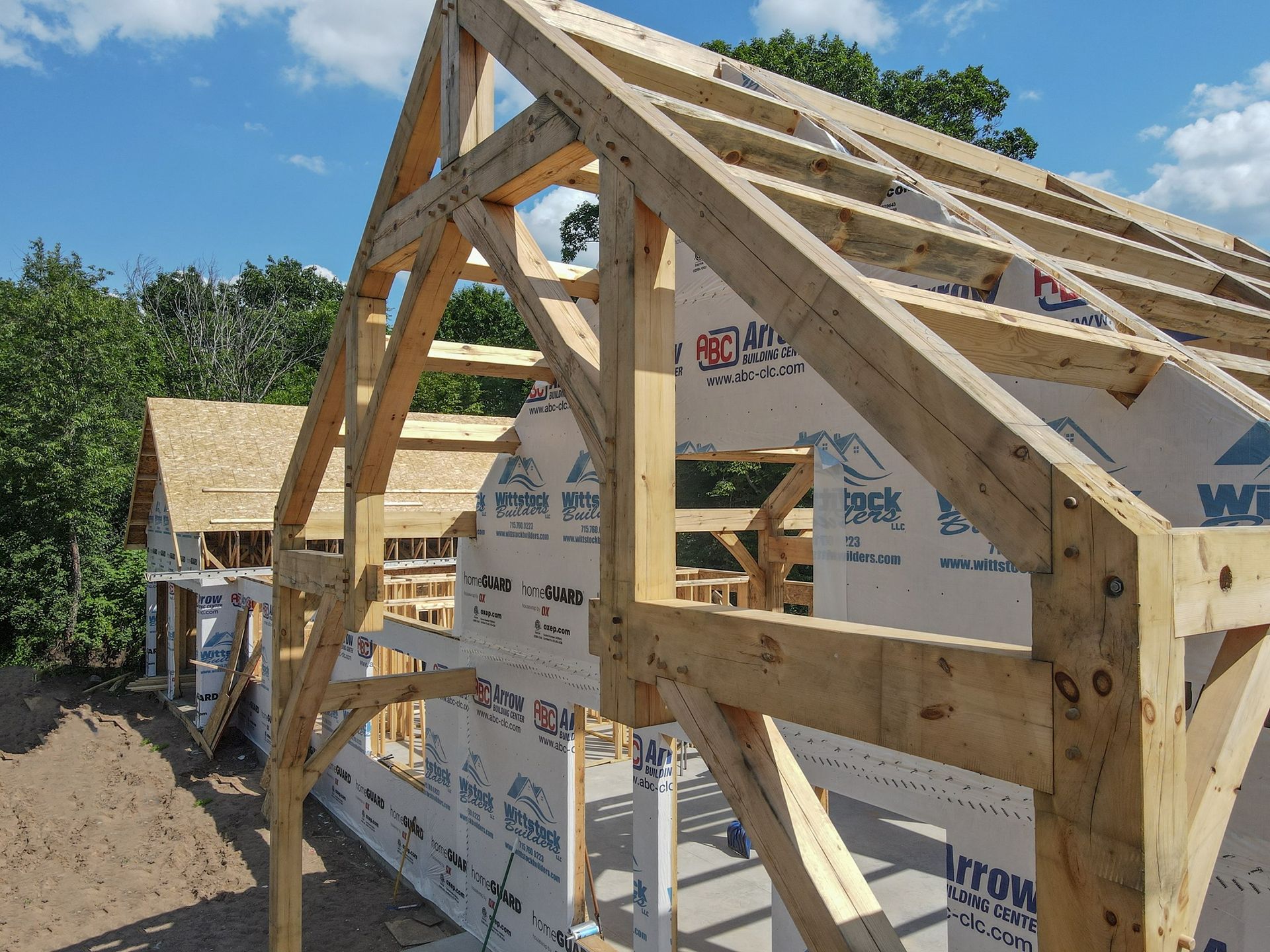 A large wooden structure is being built with a roof.