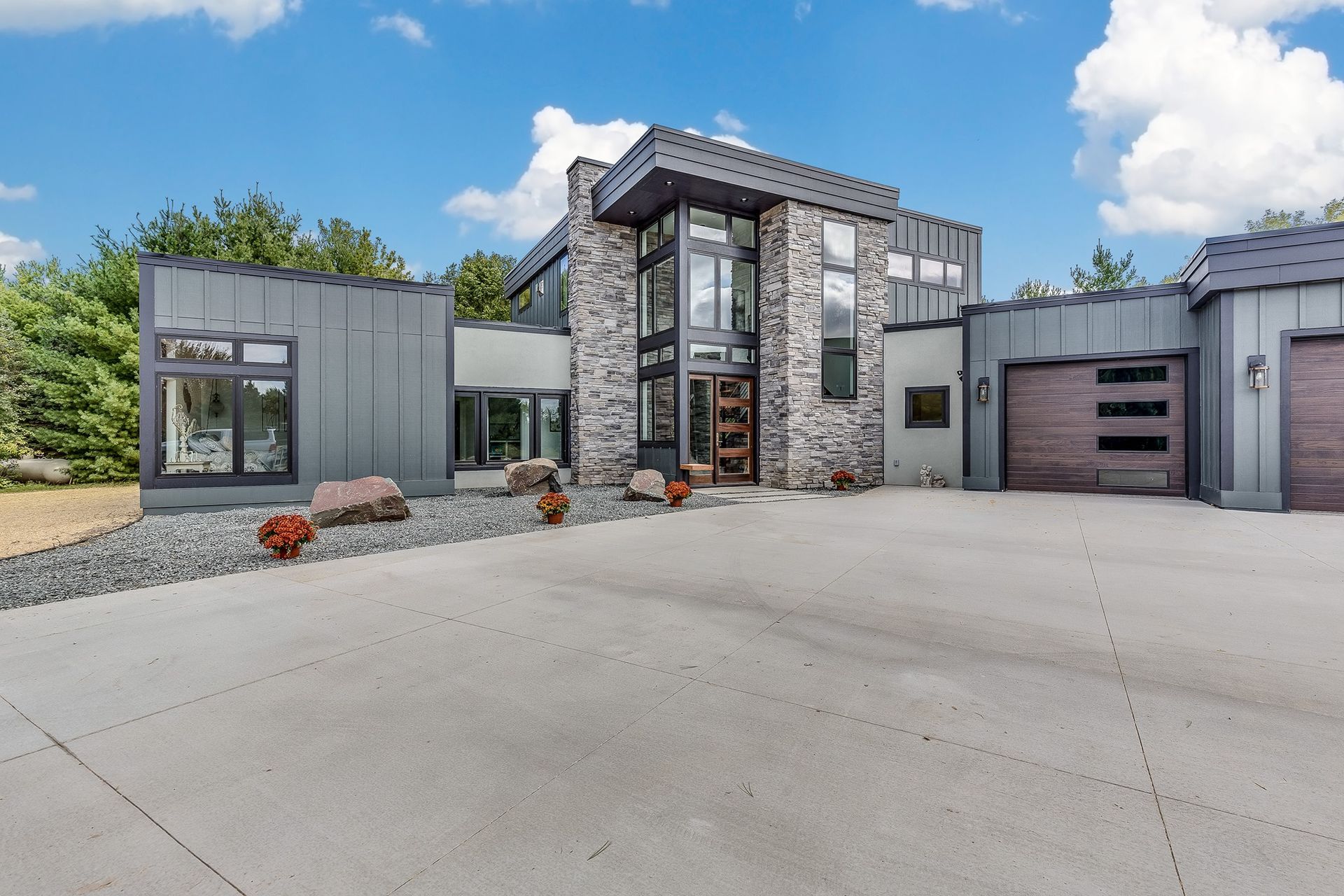 A large house with a concrete driveway in front of it
