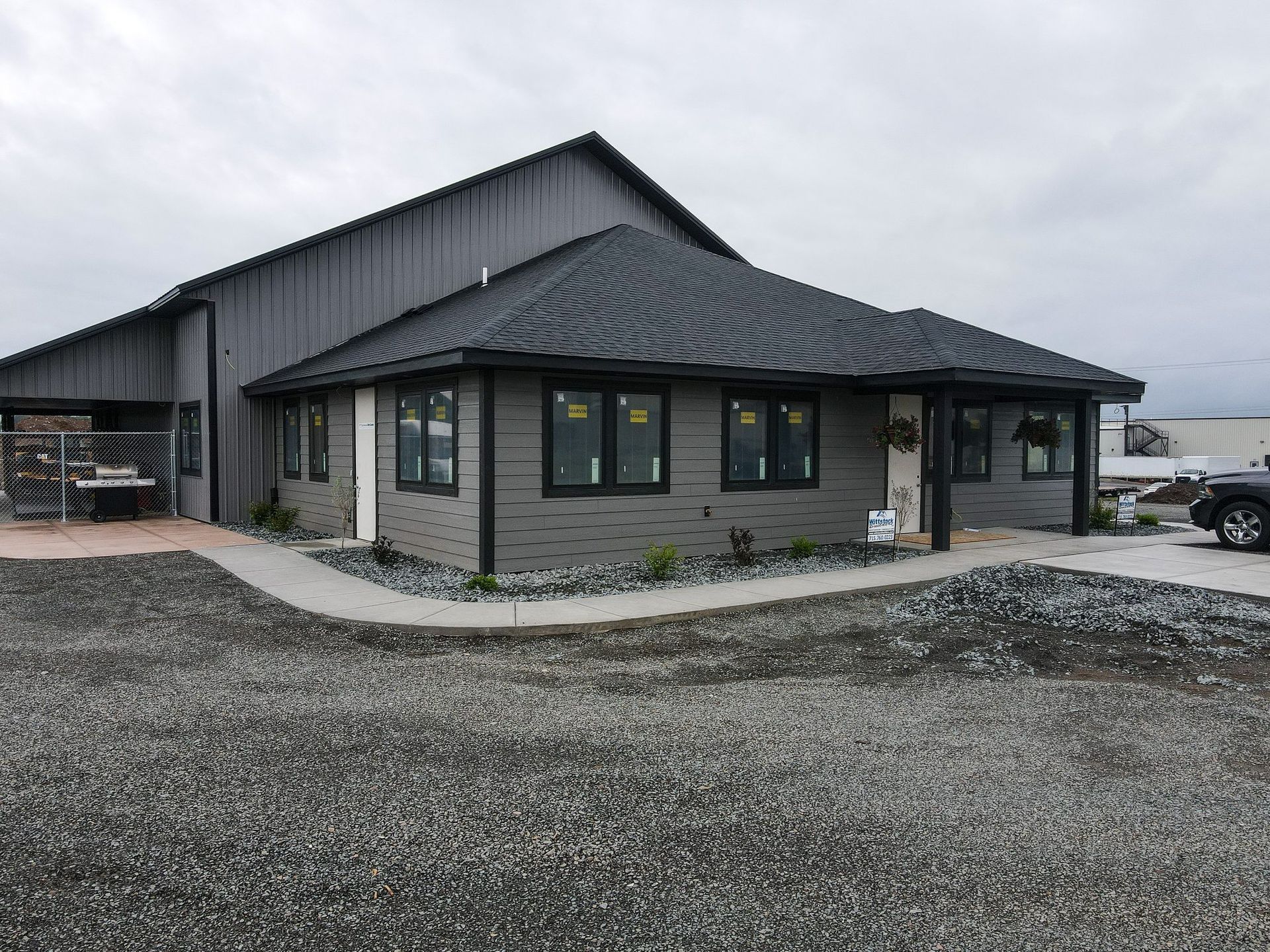 A large building with a lot of windows and a car parked in front of it.