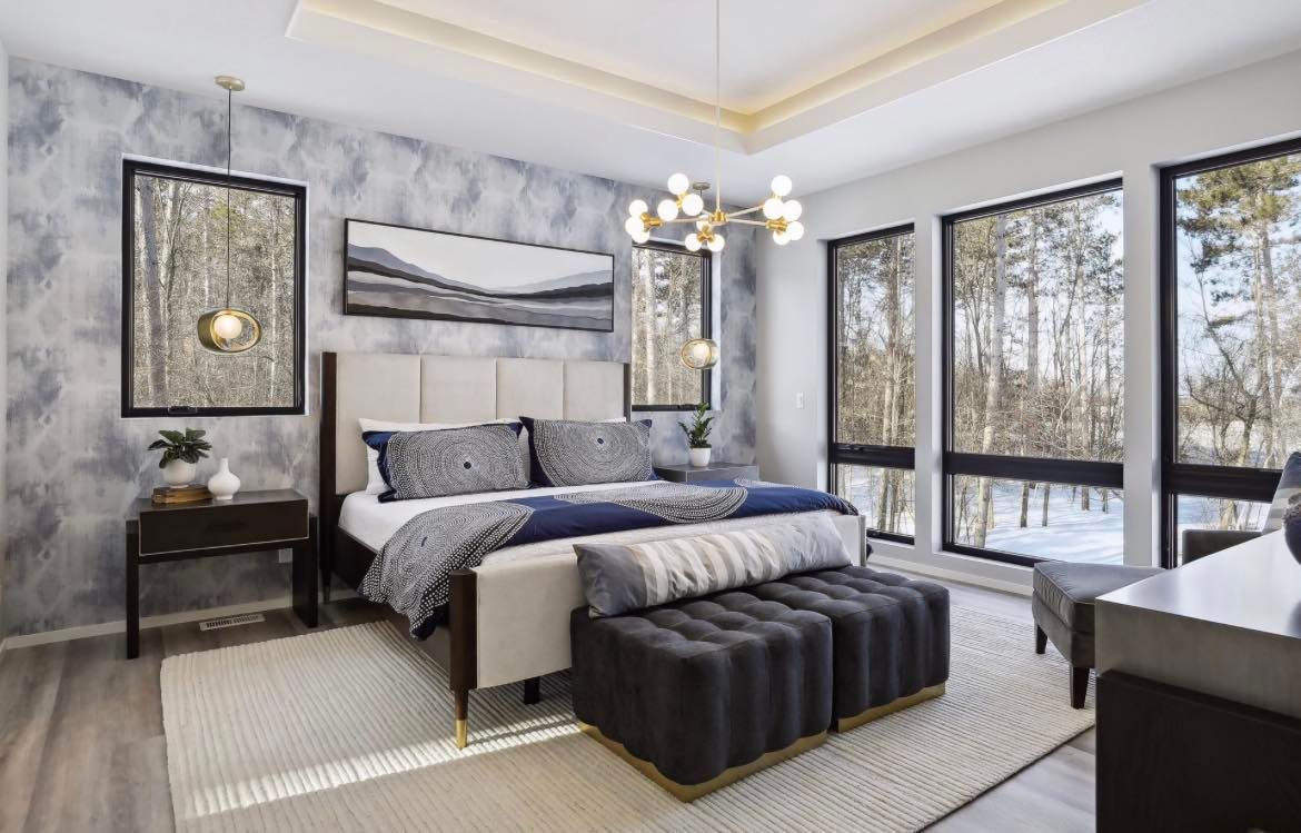 A bedroom with a large bed and lots of windows.