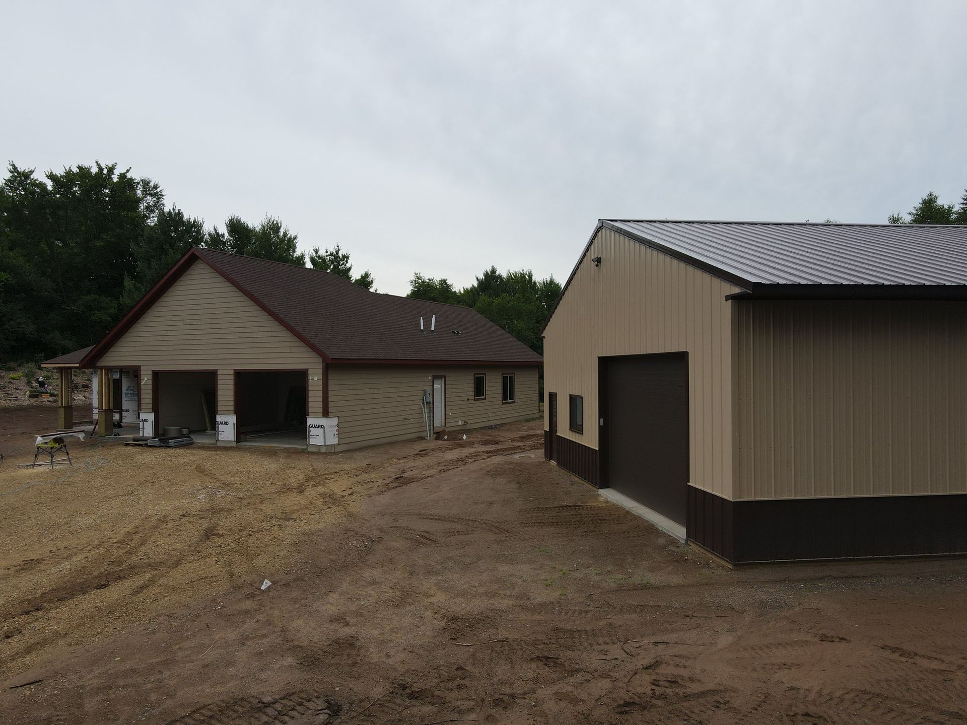 A house is being built next to a garage.