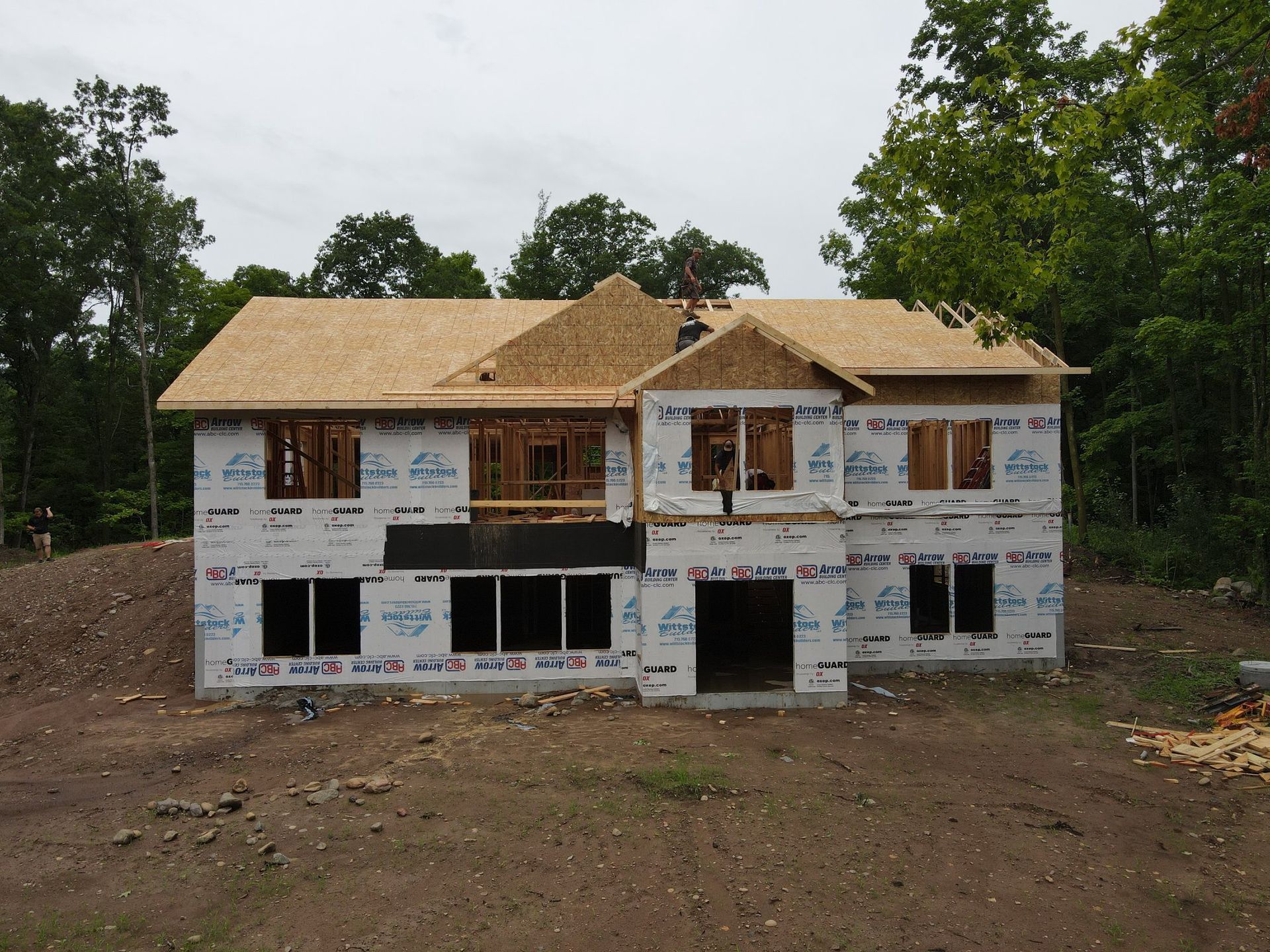 A house that is being built with a lot of windows