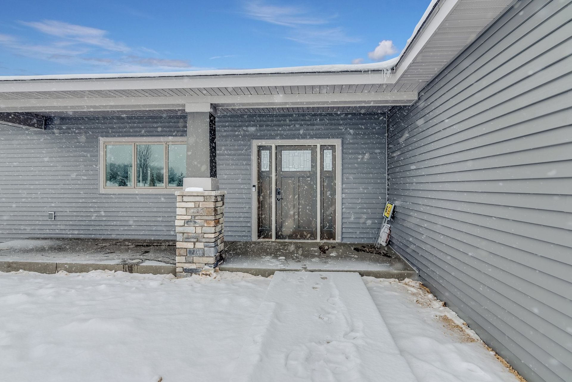 The front of a house with snow on the ground.