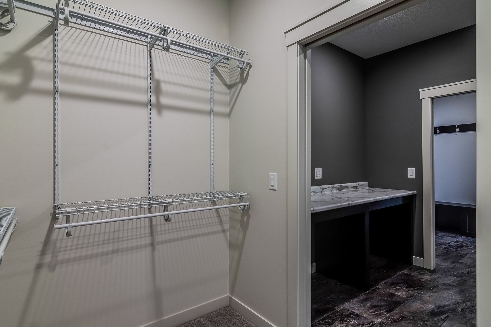A walk in closet with a sliding door leading to a bathroom.