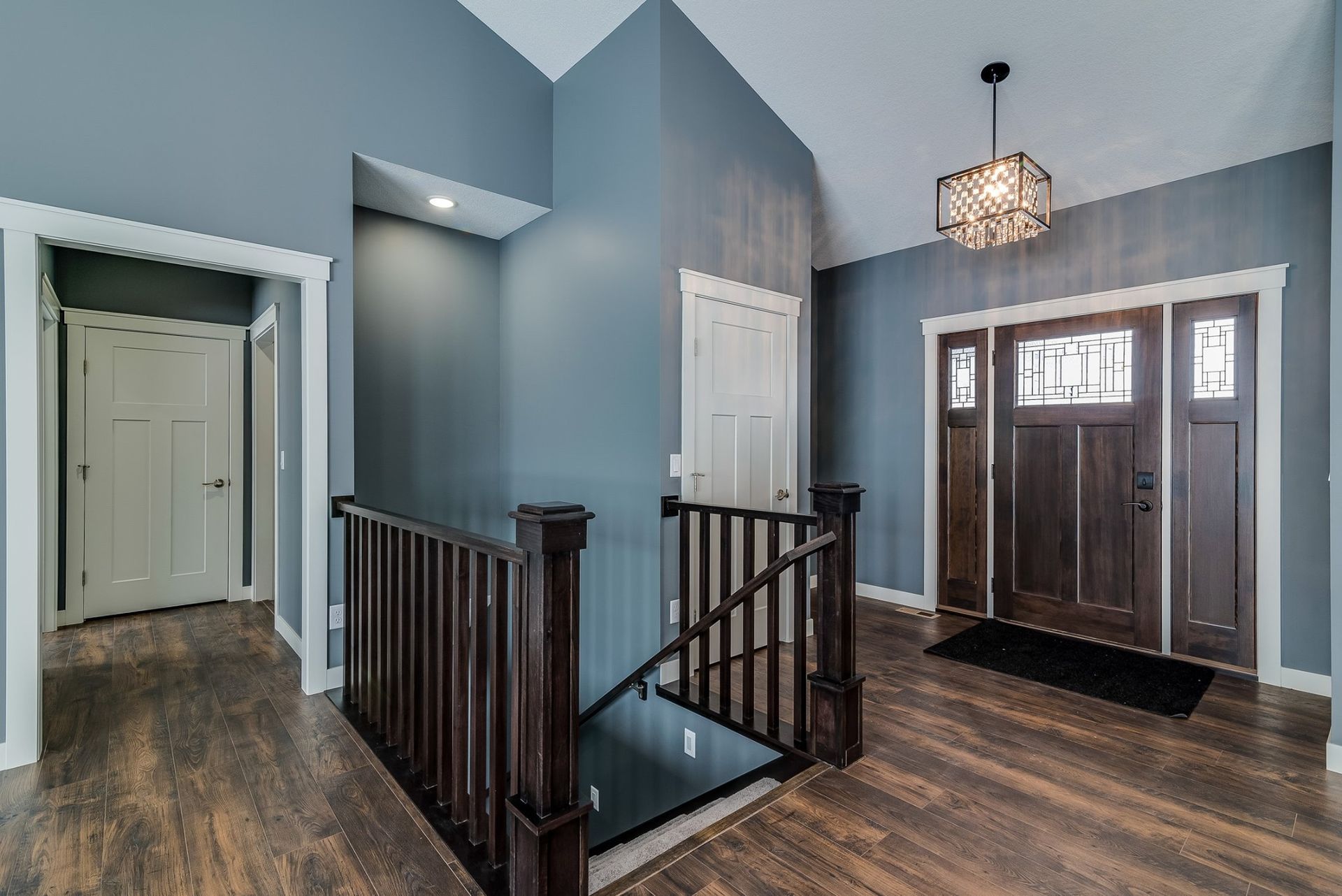 A hallway with a staircase leading up to the second floor of a house.