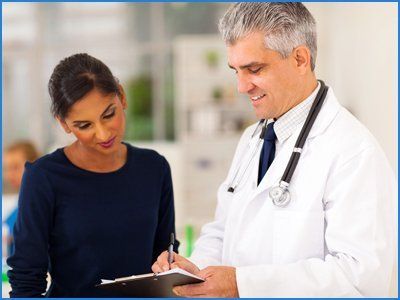 Senior doctor checking young patient's test result