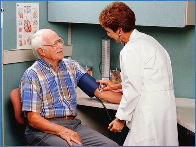Lady doctor checking BP for senior person
