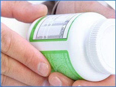 Doctor looking at a medicine bottle