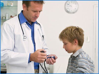 Doctor checking BP to boy