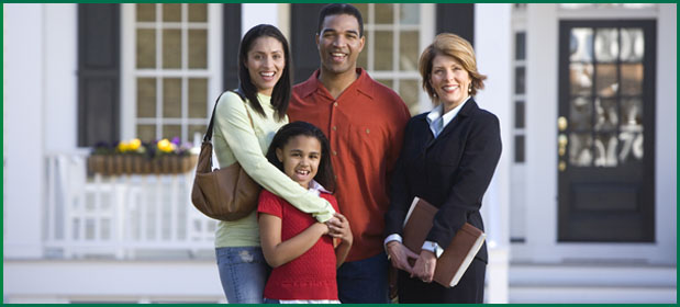 Family standing with an insurance agent