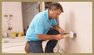 Electrician fixing power outlet