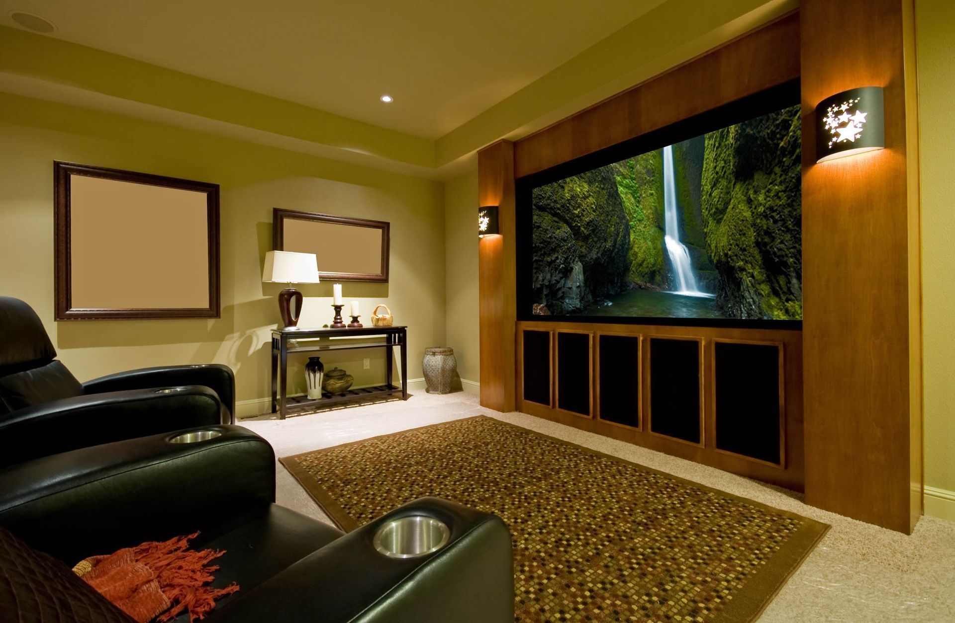 A home theater with a large screen and two chairs