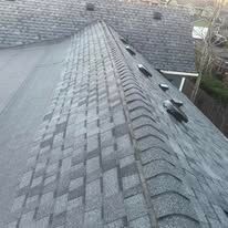 Gray asphalt shingle roof with ridge caps, perspective shot.