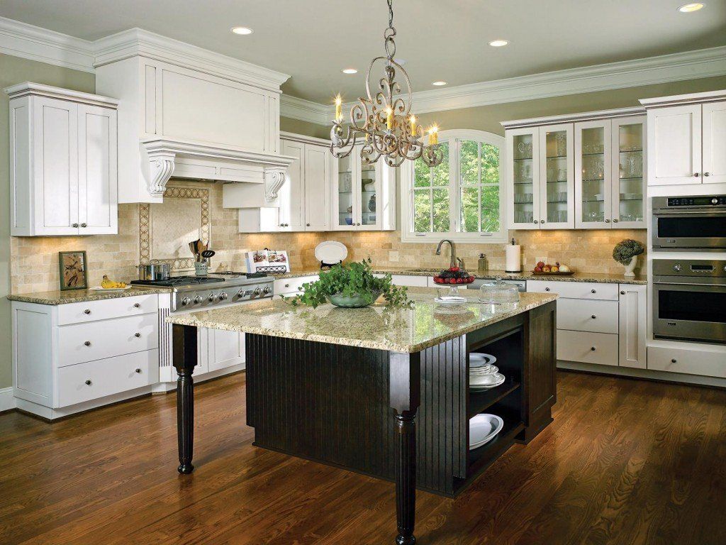 A kitchen with white cabinets and a large island
