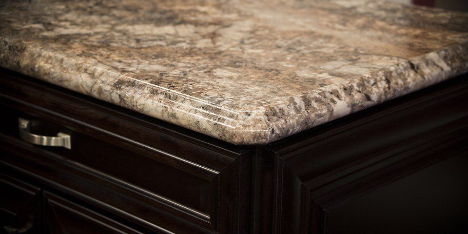A close up of a granite counter top on a kitchen island.