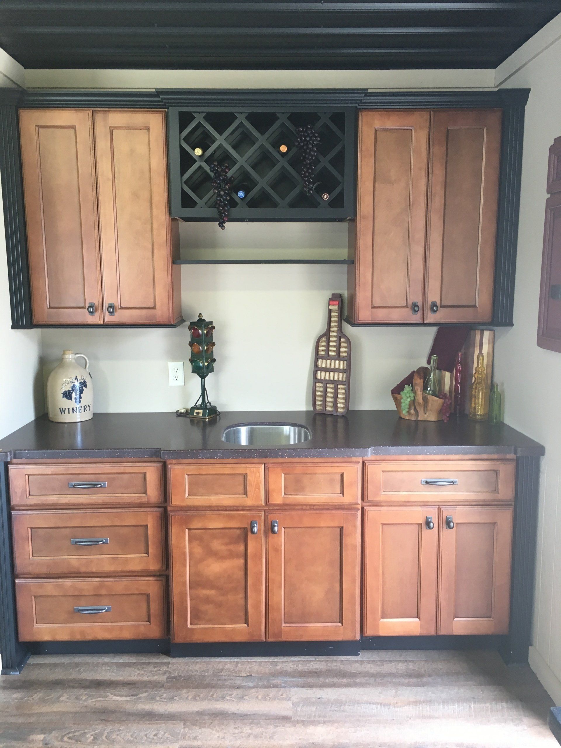 A kitchen with wooden cabinets and a wine rack