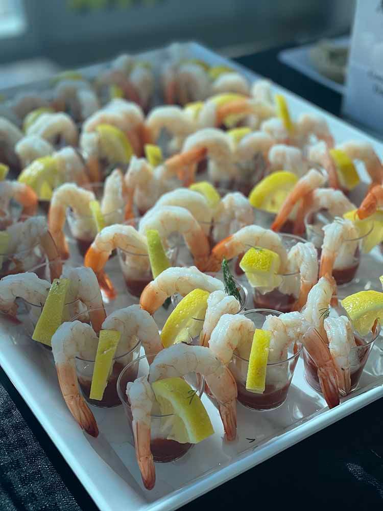 a white plate topped with shrimp and vegetables on a table