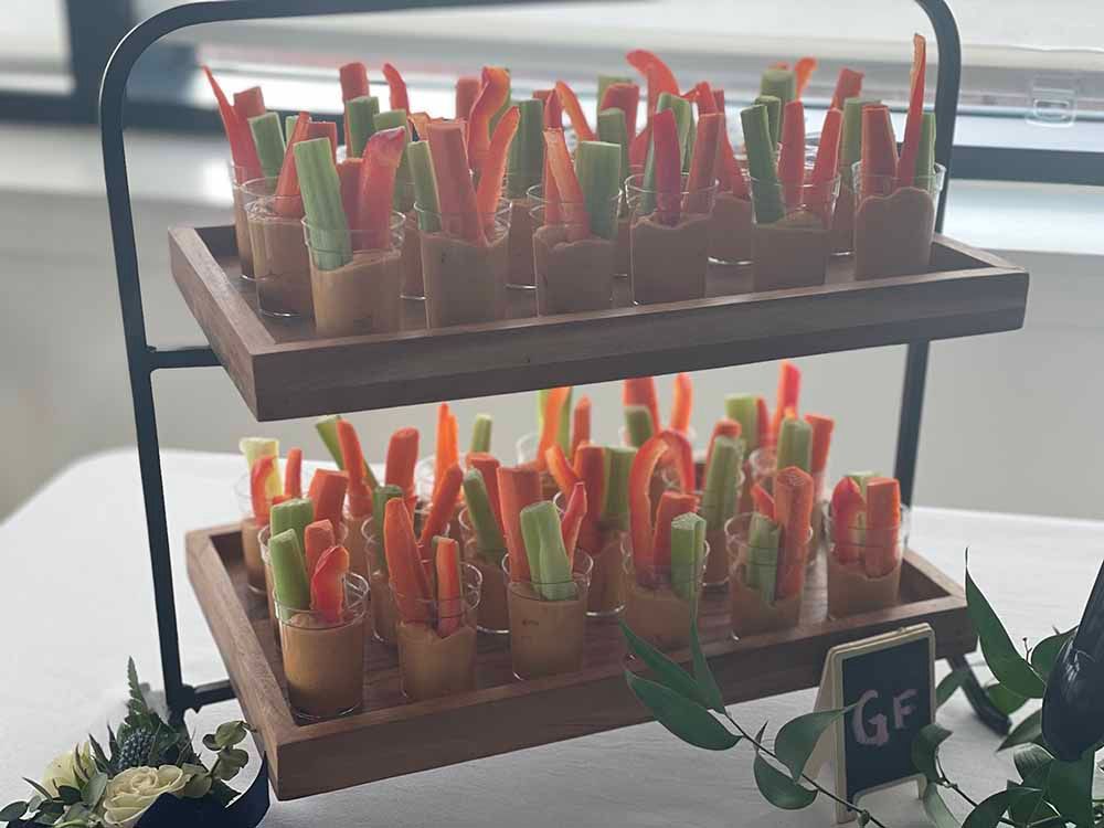 a wooden tray filled with vegetables on a table