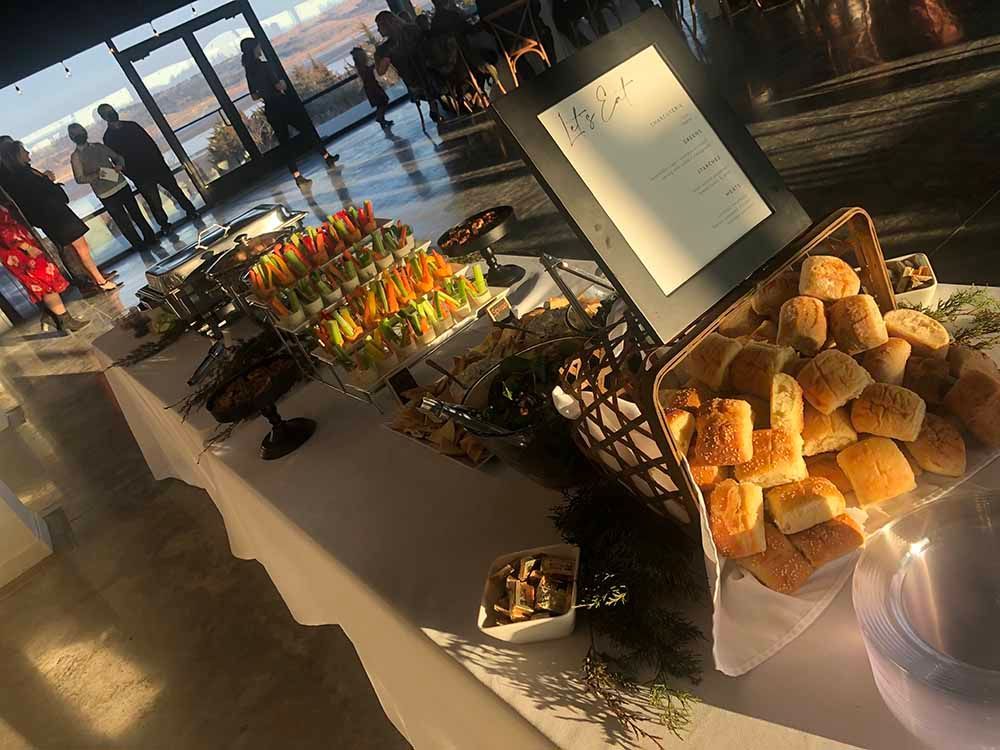 a buffet table with lots of food and a menu on it