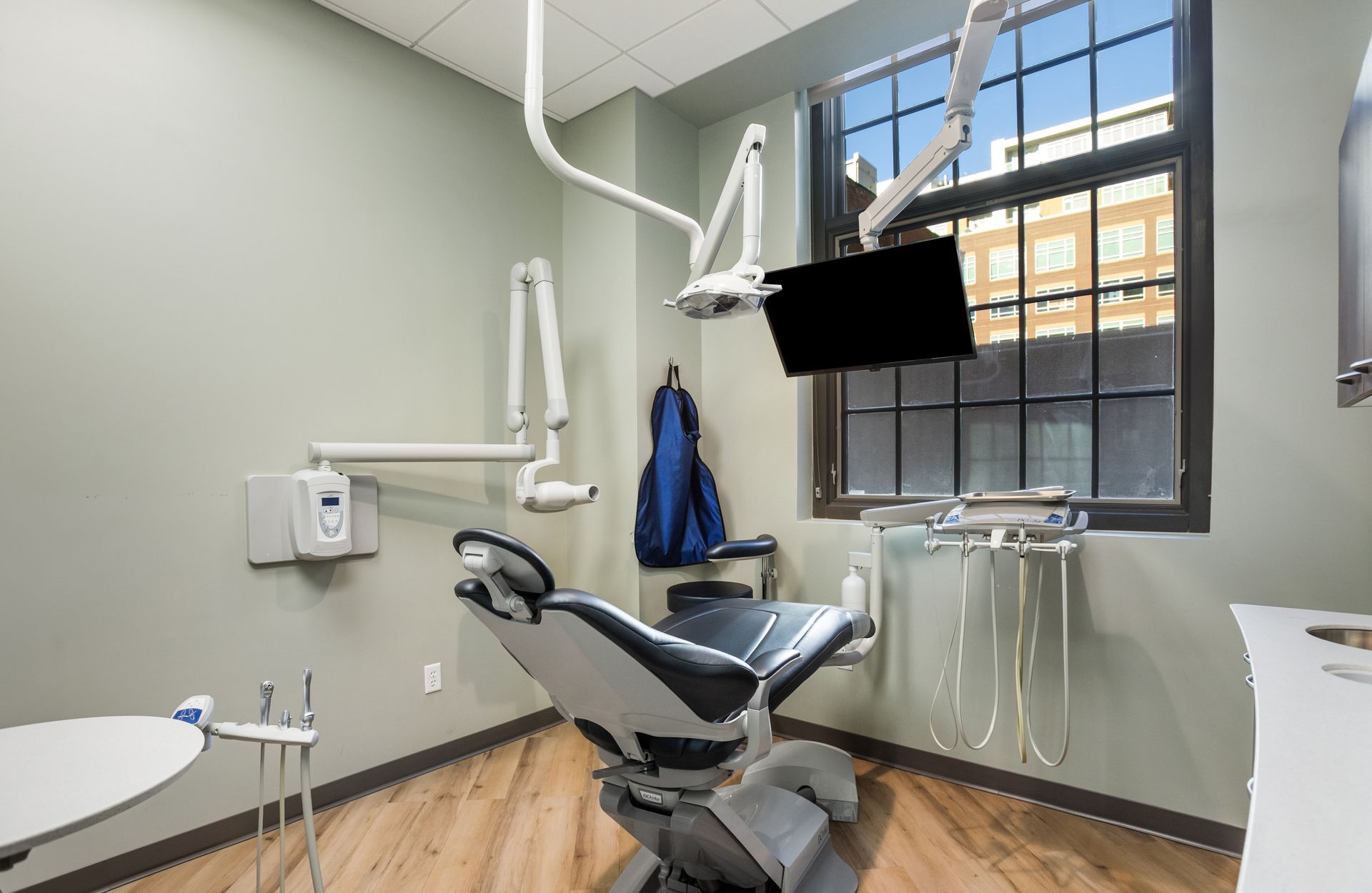 Dental operatory with chair, equipment, and window.