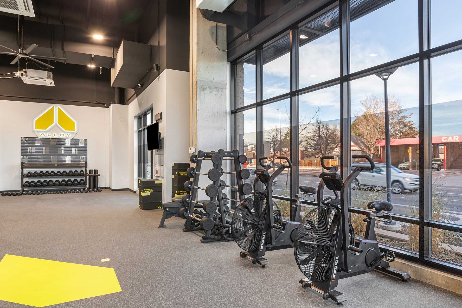gym interior with exercise equipment near large windows