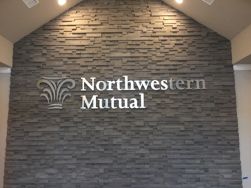 A northwest mutual sign on a brick wall