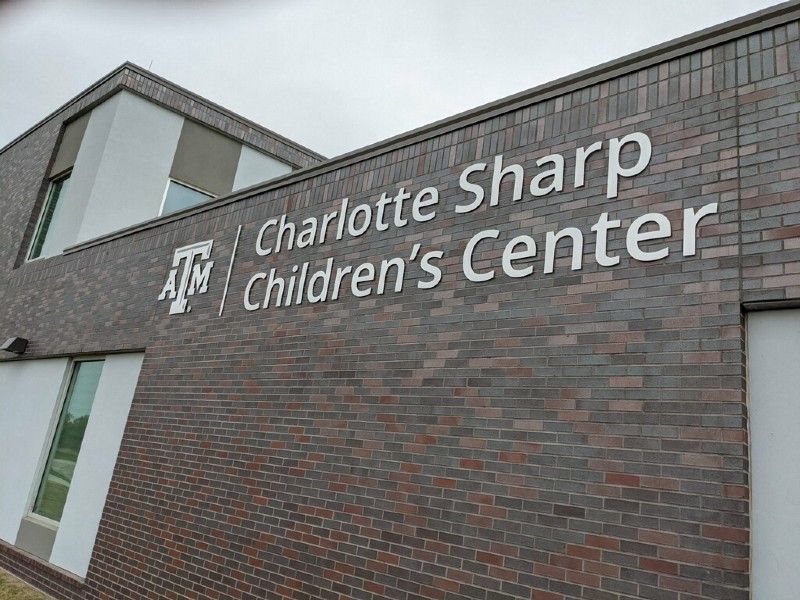 A brick building with a sign that says charlotte sharp children 's center