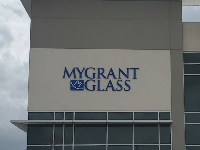 A sign on the side of a building that says mygrant glass
