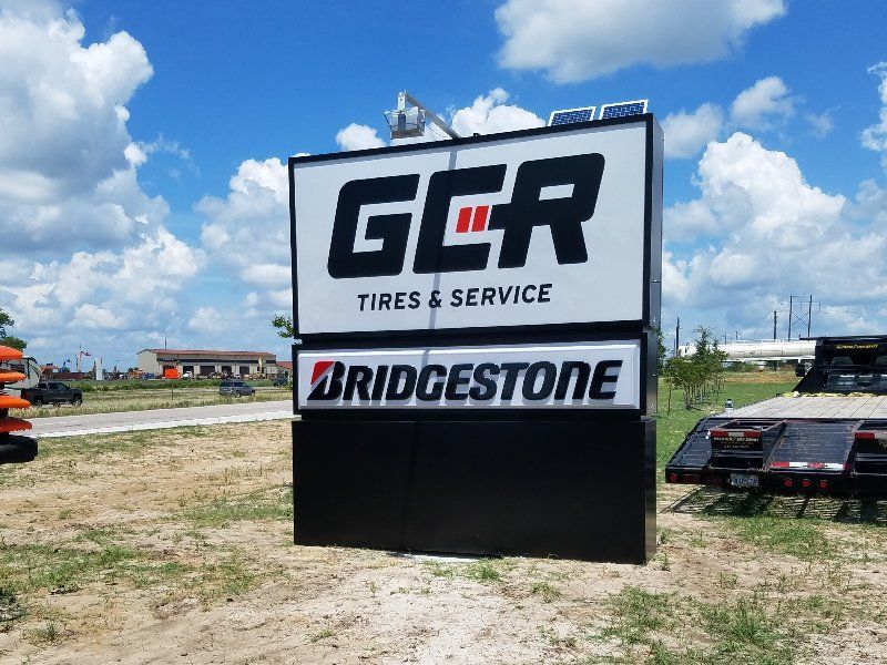 A sign that says ger tires and service on it
