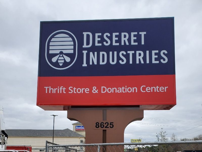 A desert industries thrift store and donation center sign
