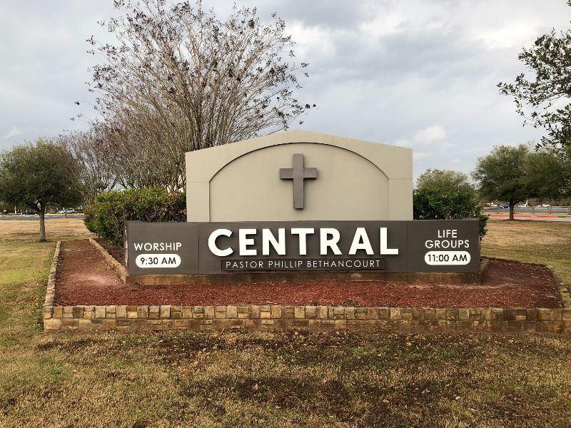 A large sign that says central with a cross on it