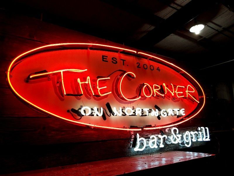 A neon sign for the corner bar and grill