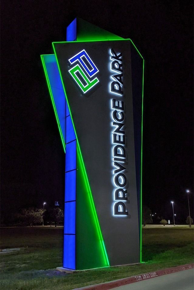 A providence park sign is lit up at night
