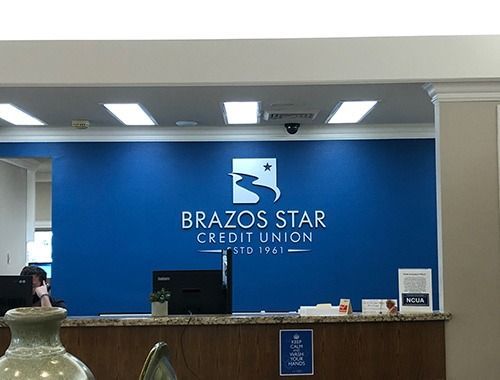 A brazos star credit union office with a blue wall