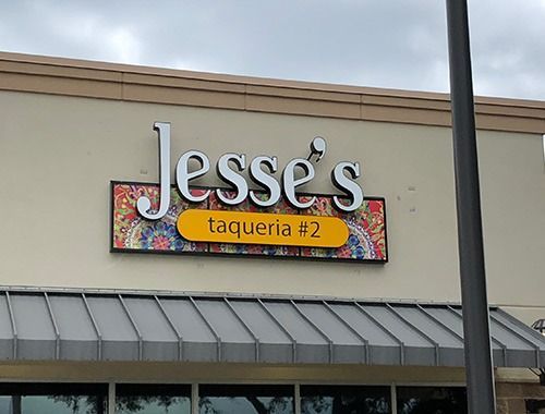 A sign for jesse 's taqueria # 2 is on the side of a building.
