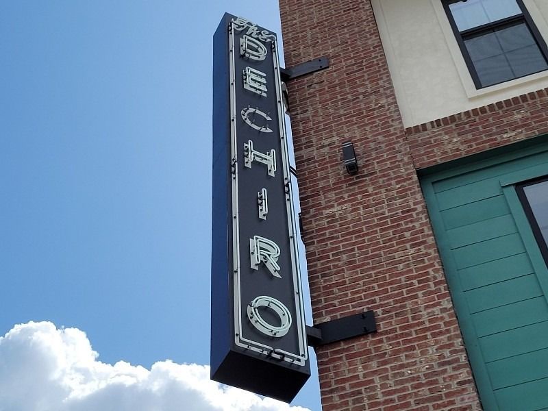 A sign on the side of a building that says downtown
