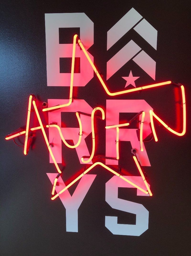 A neon sign that says ' boston ys ' on it