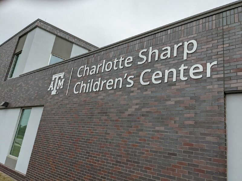 A brick building with a sign that says charlotte sharp children 's center