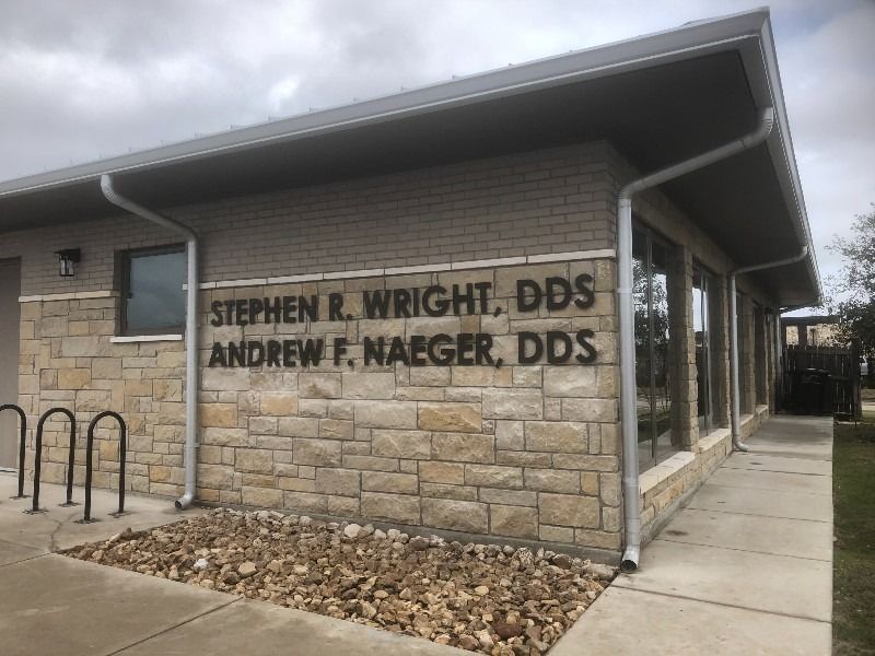 A brick building with a sign that says stephen r. wright dds andrew f. naeger dds