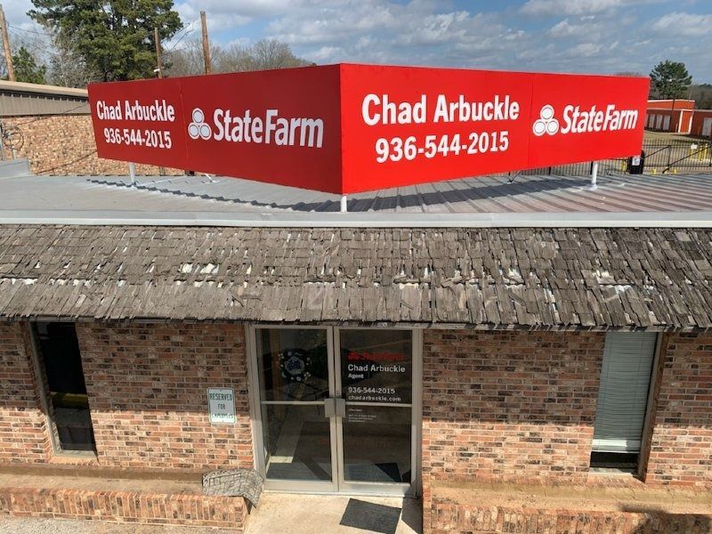 A brick building with a red sign that says chad arbuckle state farm